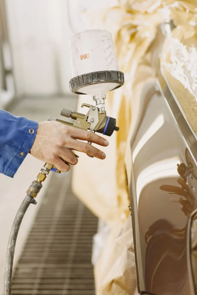 Technician refinishing a car after an insurance claim in Markham